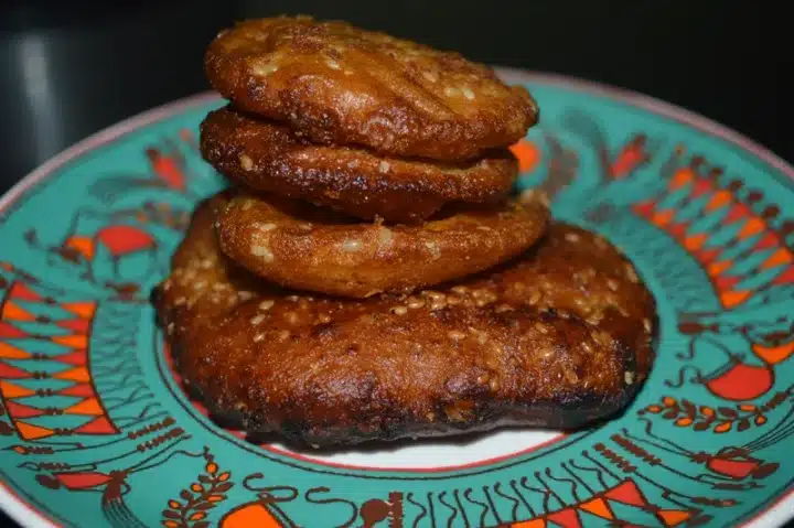 A shot of a traditional Rath Yatra Food Arisa Pitha stacked on top of each other served on a beautifully crafted plate