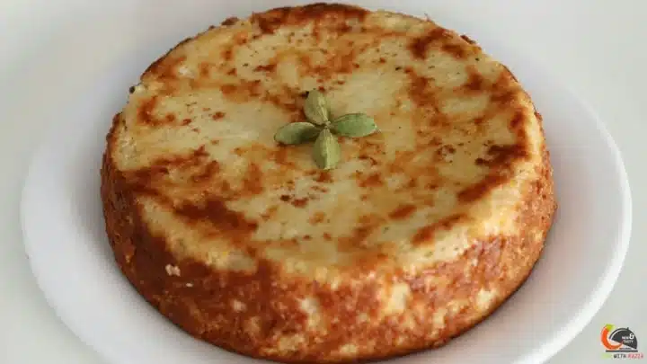 A shot of a traditional Rath Yatra Food Chenna Poda garnished with cardamom