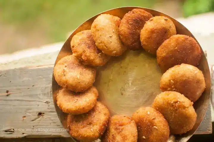 A shot of a traditional Rath Yatra Food Kakara Pitha stacked on top of each other served on a round fashion on a plate