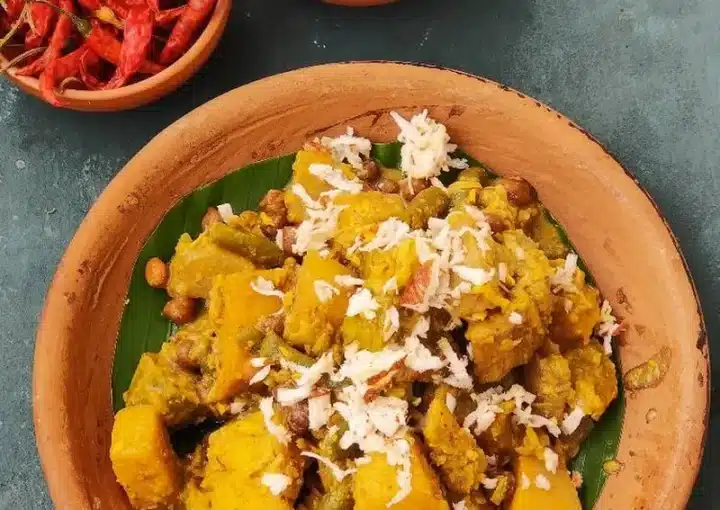 Traditional Rath Yatra Food Mahura in a bowl. There's also a small bowl of red chillies on the side.