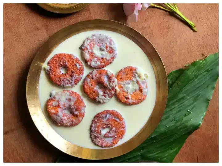 A shot of a traditional Rath Yatra Food Rasabali with leaf and flower in the background