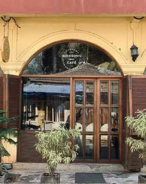 An image of birdsong cafe having brown aesthetic doors.