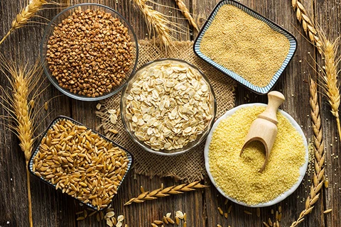 An image of different types of raw or uncooked whole grains.