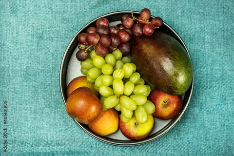 Image of fruits and berries like apples, oranges, berries, and grapes.